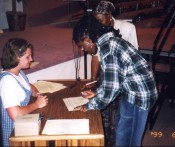 A young woman signs her Covenant of Godly Womanhood.